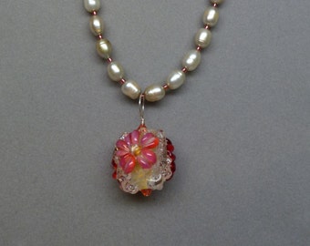 A Golden Glass Textured Round Lampwork Bead (1S29) with Three Surface Flowers on a Freshwater Pearl Strand