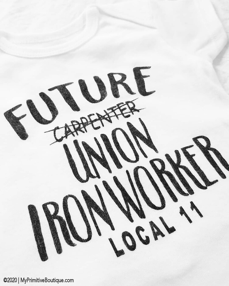 May include: White t-shirt with black text that reads "FUTURE CARPENTER UNION IRON WORKER LOCAL 11". The word "CARPENTER" is crossed out.