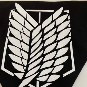 May include: Black fabric patch with a white winged emblem. The emblem is a stylized wing with a central vertical line and a rectangular frame.