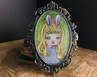 Portrait of a fluffy bunny, conte pencil pastel drawing on metal frame. A pop surreal self portrait of Danita with pink hairy rabbit ears.