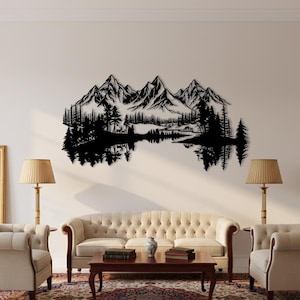 May include: Black metal wall art depicting a mountain range, trees, and a lake with reflections. The artwork is mounted on a white wall above a sofa and chairs. The scene includes a detailed silhouette of a natural landscape.