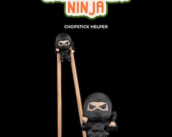 May include: Chopstick helper with a black ninja figure holding onto the chopsticks. The text "ChopStealth Ninja" and "Chopstick Helper" is printed on the image.