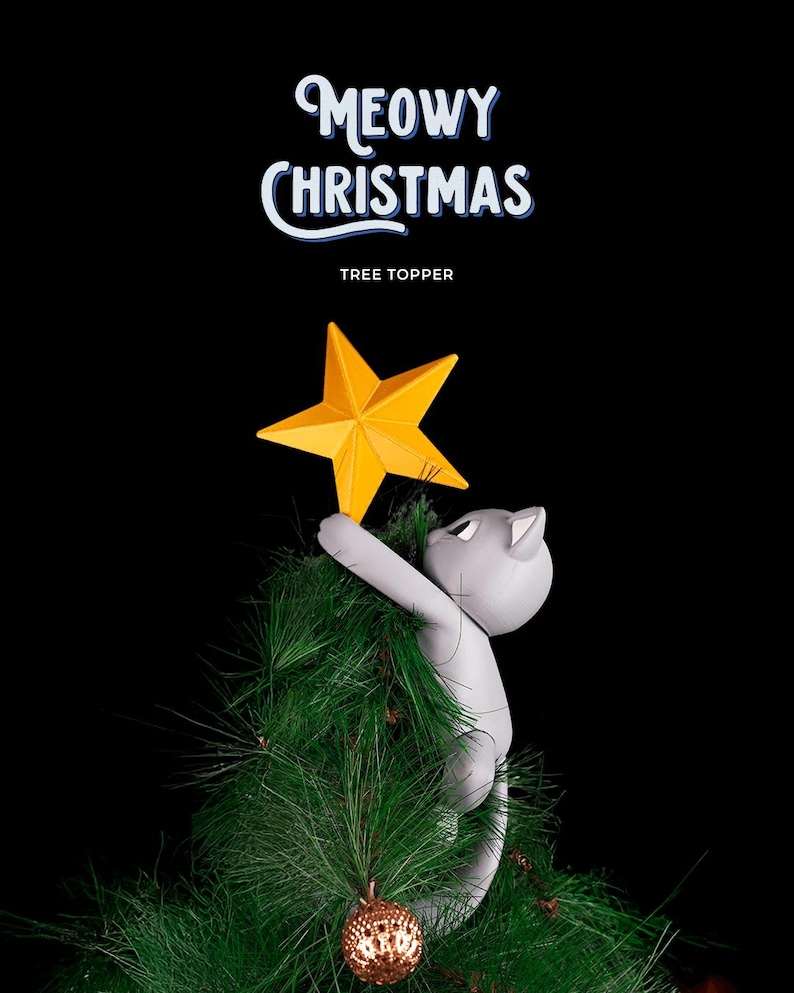 May include: A gray cat-shaped Christmas tree topper holding a yellow star. The cat is climbing a green artificial Christmas tree. The words "Meowy Christmas" and "Tree Topper" are written in white and blue on a black background.