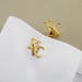 May include: A pair of gold cufflinks with the letters "KC" engraved on them.