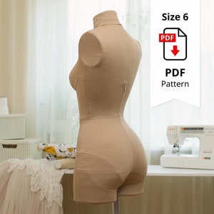 May include: A beige dress form with a high collar and short shorts. The form has a zipper down the back and is designed for sewing. The image includes a PDF pattern graphic with the text "Size 6" and "PDF Pattern".