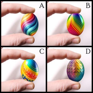 May include: Four decorative Easter eggs with colorful designs are held between fingers. Each egg features a unique pattern: swirling rainbow, striped rainbow, floral and geometric patterns. The eggs are vibrant and eye-catching.