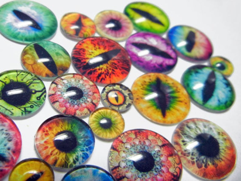 May include: Assortment of colorful glass eyes with various designs, including a circuit board, a rainbow, and a dragon eye. These glass eyes are perfect for crafting projects.