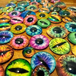 May include: Assortment of colorful glass eyes with various patterns and designs. The eyes are round and have a black pupil in the center. They are perfect for crafting projects.