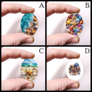 May include: Four oval-shaped pendants with beach-themed designs. Each pendant features a different coastal scene: crashing waves, colorful seashells, a beach with starfish, and a collection of seashells and starfish on a white background. The pendants are held by fingers.