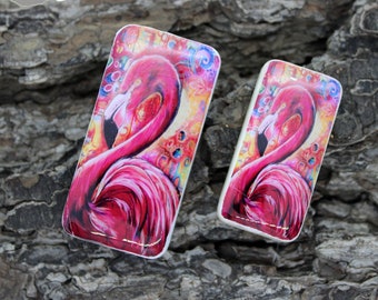 May include: Two rectangular ceramic tiles with a colorful abstract design featuring a pink flamingo. The tiles are different sizes.