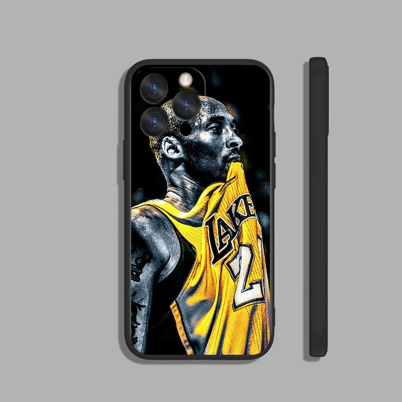 May include: Black and white illustration of a basketball player wearing a yellow and black Lakers jersey with the number 24 on the front. The player is looking up and has a determined expression on his face.