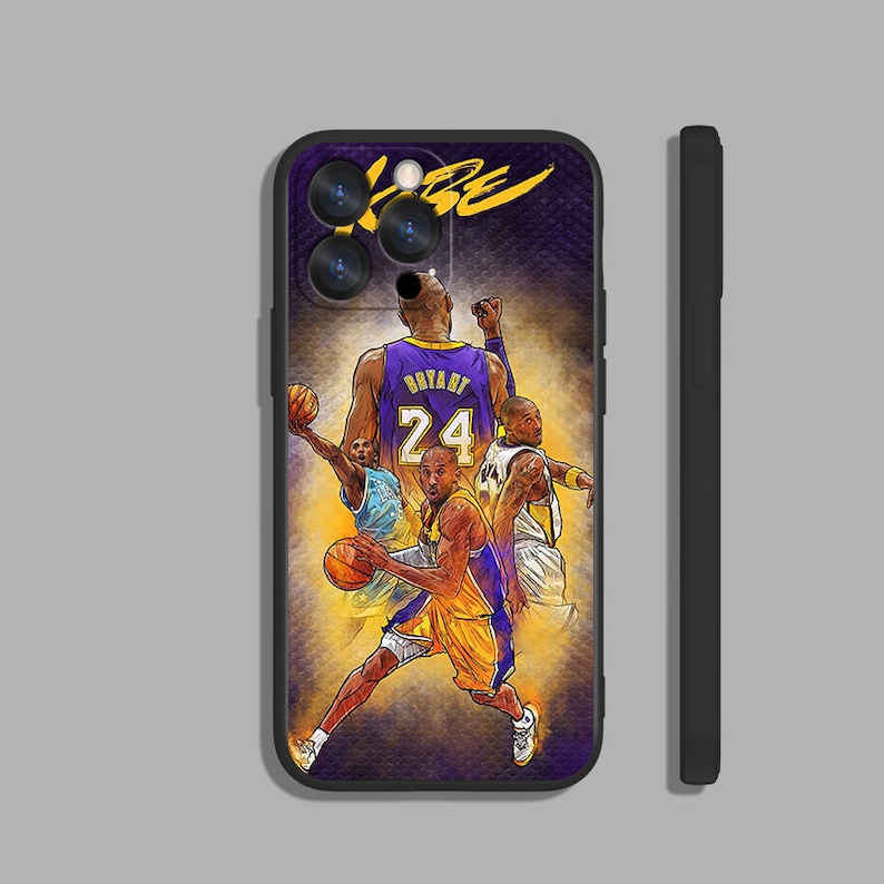 May include: Black phone case with a purple and yellow basketball design featuring Kobe Bryant in a Lakers jersey with the number 24. The case has a black border and a raised camera bump.