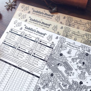 May include: A stack of three illustrated game boards with the text "Goblin's Hoard Easter Escapade: Savings Challenge" and "Springveil". The boards feature a black and white map design with various locations and character illustrations. Additional game pieces are visible.