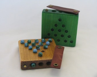 Solitaire Game that stores the marbles inside.