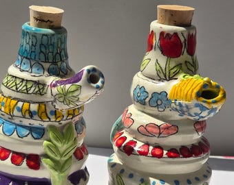 pair of little ceramic shakers, oil vinegar, salt and pepper, or cream and sugar.