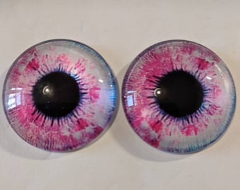 One pair of glass eyes pink  colour various  sizes