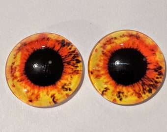 One pair of glass eyes yellow /orange colour various  sizes