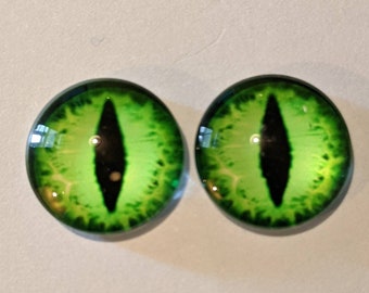 May include: Two green glass eyes with black pupils, resembling a cat's eyes.