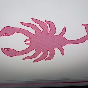 May include: A pink silhouette of a scorpion with a detailed design. The scorpion is facing right and has a long tail.
