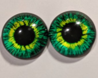 One pair of glass eyes green colour  various sizes