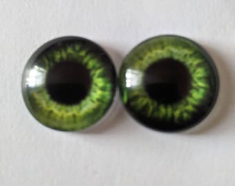 One pair of glass eyes green various sizes