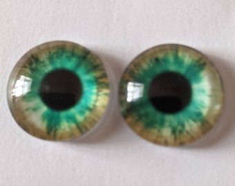 One pair of glass eyes green various sizes