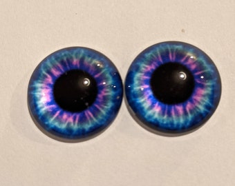 One pair of glass eyes blue and pink colour with metal loops various  sizes