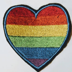 May include: Embroidered rainbow heart patch with red, orange, yellow, green, blue, and purple stripes.