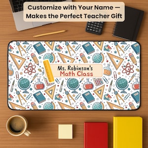 May include: A personalized desk mat with a white background and a pattern of school supplies. The mat features the text "Ms. Robinson's Math Class" and the words "Customize with Your Name - Makes the Perfect Teacher Gift".