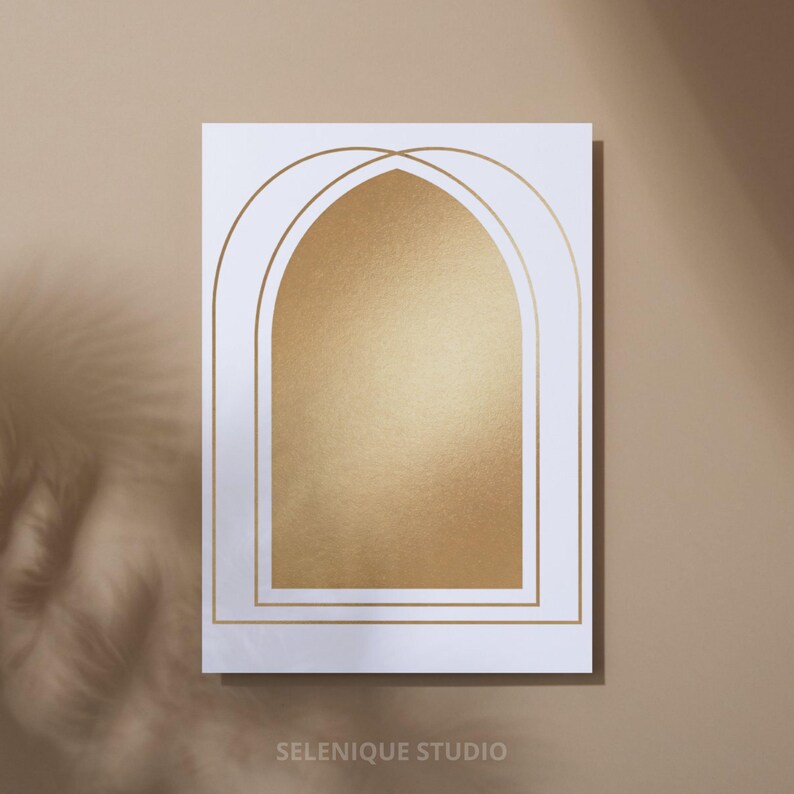 May include: A white rectangular print featuring a gold foil arched design. The design is framed by gold lines and filled with a gold foil background. The text "SELENIQUE STUDIO" is printed at the bottom.