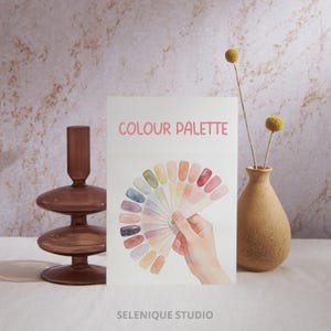 May include: A watercolor illustration of a color palette fan with various shades of color. The text "COLOUR PALETTE" is at the top. A brown vase with yellow flowers and a brown glass candle holder are also in the image. The text "SELENIQUE STUDIO" is at the bottom.