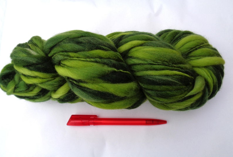 May include: A skein of green and black wool yarn. The yarn is twisted and has a striped pattern.