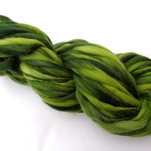 May include: A skein of green and dark green hand-dyed wool yarn. The yarn is thick and fluffy, and it is perfect for knitting or crocheting.