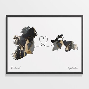 May include: An abstract map of Ireland in black and gold connected to an abstract map of Tajikistan in black and gold by a line with a heart in the middle. The text "Ireland" is below the map of Ireland and the text "Tajikistan" is below the map of Tajikistan.