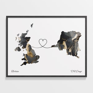 May include: A black and white map print with gold accents showing the outlines of Great Britain and the Democratic Republic of the Congo connected by a line forming a heart shape. The text "Britain" and "DR Congo" are printed below the maps.