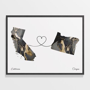 May include: A black and gold marble print map of California and Oregon connected by a heart-shaped line. The states are labeled "California" and "Oregon".