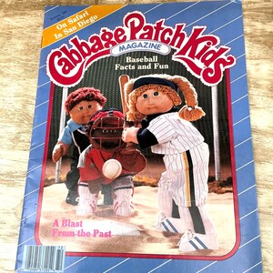 May include: A Summer 1987 Cabbage Patch Kids magazine titled On Safari In San Diego and Baseball Facts and Fun. The cover features three dolls dressed in baseball uniforms on a field, with a baseball in motion and the text A Blast From the Past.