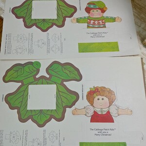 May include: Two sheets of Cabbage Patch Kids paper gift tags featuring illustrations of children in holiday attire, green cabbage leaves, and instructions. The text reads: The Cabbage Patch Kids wish you a Merry Christmas! and Cabbage Patch Kids.