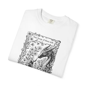 May include: A white t-shirt featuring a black ink-style graphic of a person touching a dragon's nose amidst flowers. The text above the illustration reads, "One boop, if thou wilt." The shirt has a Comfort Colors brand label at the neck.