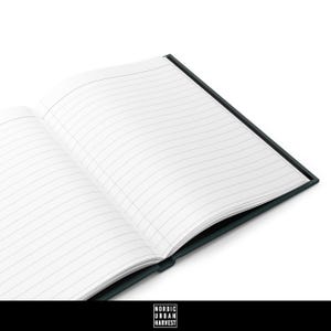 May include: A dark green lined notebook with a black spine. The notebook is open to a blank page with lined paper.