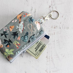 Moths and mushrooms on grey ID holder key ring zip pouch