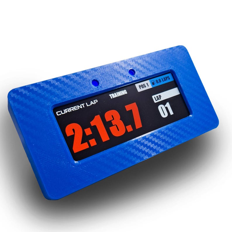 May include: A blue rectangular digital timer with a black screen displaying "2:13.7" in orange. The timer also shows "CURRENT LAP", "TRAINING", "LAP 01", and "POS 1 0.0 LAPS". The device has a textured surface.