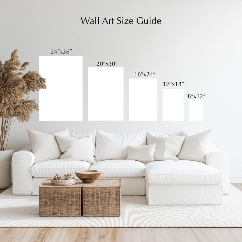 a living room with a white sofa and a coffee table. Above the sofa, there are five framed artworks of different sizes, ranging from 24"x36" to 20"x30" and 8"x12". The wall art guide provides the corresponding dimensions for each artwork.