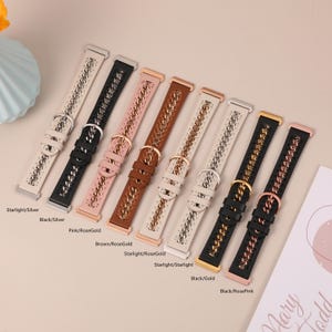 May include: An assortment of watch bands in various colors, including black, pink, brown, and white. Each band features a chain design and a buckle closure. The bands are displayed on a light-colored surface.
