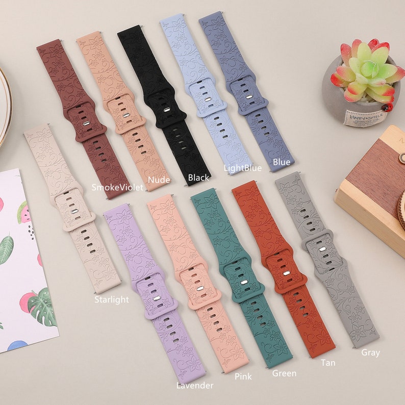 May include: Ten different colored silicone watch bands with a floral pattern. The colors are: smoke violet, nude, black, light blue, blue, starlight, lavender, pink, green, tan, and gray.