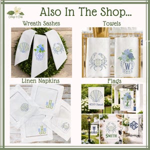 May include: A selection of coastal-themed home decor items, including white wreath sashes, towels, linen napkins, and garden flags. The items feature embroidered designs of seashells, crabs, and floral arrangements. Some flags display text such as "4059 Sunset" and "Smith".
