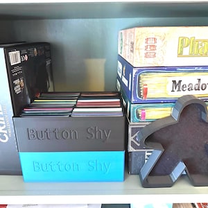STL File for Extra large Button Shy Wallet Game holder. Can be Stack-able.