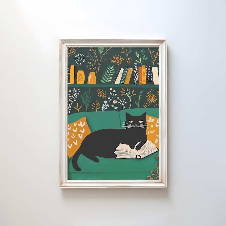 May include: A framed art print featuring a black cat lounging on a green sofa, reading a book. The background showcases a bookshelf with books and decorative items, and floral wallpaper. Orange pillows add a pop of color.