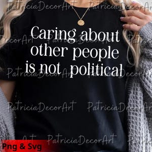 Könnte beinhalten: Schwarzes T-Shirt mit dem weißen Text "Caring about other people is not political." Das Shirt hat auch den Text "Png & Svg" unten. Eine goldene Halskette ist sichtbar.