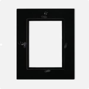 May include: A rectangular black picture frame with a white interior. The frame has a simple, classic design with a flat surface. Metal hardware is visible on the back for hanging. This frame is suitable for displaying photographs or artwork.